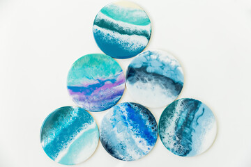 Resin art plates with bright turquoise and blue colors on white background. Plates with Epoxy effect