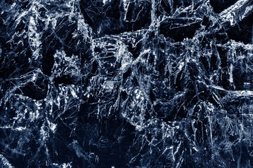 Wall Mural - Macro photo of transparent dark blue ice of frozen Baikal lake with white frost ornament. Beautiful winter nature background.