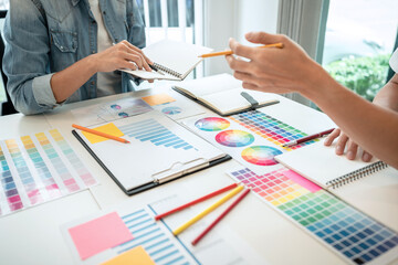 Aufkleber - Two creative graphic designer team working on color selection and drawing on graphic tablet, Color swatch samples chart for selection coloring in inspiration to creativity at workplace