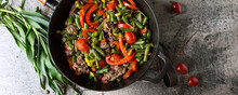 Venison Stew With Green Beans And Bell Peppers In A Frying Pan On The Table