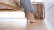 © ShantiMedia - Close-up of female bare feet go along the floor in the bedroom to the bed and goes to sleep on the bed. Women's legs in pajamas in the bedroom. Usual end of the day at home.