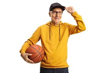 Canvas Print - Cheerful elderly man holding a basketball and greeting with cap