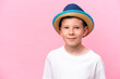 © luismolinero - Little caucasian boy wearing a hat isolated on pink background
