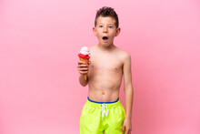 Little Caucasian Boy Eating An Ice-cream Isolated On Pink Background With Surprise And Shocked Facial Expression