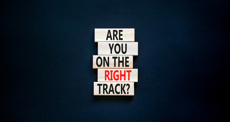 Right track symbol. Concept words Are you on the right track on wooden blocks on a beautiful black table black background. Copy space. Business motivational and right track concept.