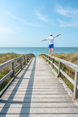 Wall Mural - young man enjoying his freedom near the beach