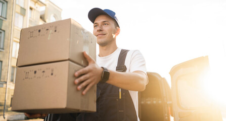 The driver in the uniform of the courier company fast delivery of goods to the house.