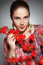 Closeup Portrait Of Beautiful Young Fashion Woman With Makeup Posing Near Roses In A Garden