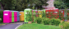 Portable Colored Mobile Toilets In The Park. A Line Of Chemical Toilet Cubicles For The Euroflora Event 2022 Genoa Italy