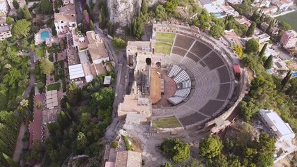 Wall Mural - Aerial drone. The ancient Greek theatre and town of Taormina, Sicily, Italy.
