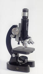 Wall Mural - old analog microscope, mirror on white background with copy space