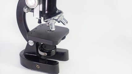 Wall Mural - old analog microscope, mirror on white background with copy space