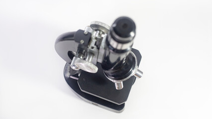 Wall Mural - old analog microscope, mirror on white background with copy space