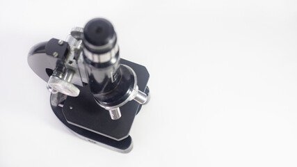 Wall Mural - old analog microscope, mirror on white background with copy space