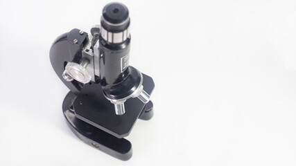 Wall Mural - old analog microscope, mirror on white background with copy space