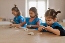 Group Of Little Kids Working With Pottery Clay During Creative Art And Craft Class At School.