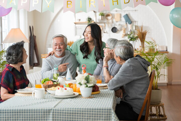 Group of Asian senior people having birthday party at home, celebrating birthday at retirement home with friends