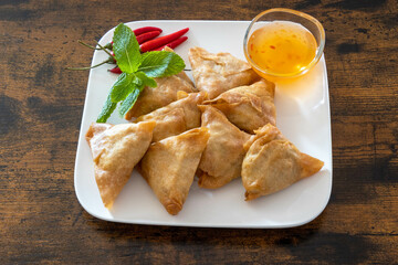 Wall Mural - top view of samosa in a white plate with sweet and sour sauce