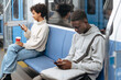 © yurolaitsalbert - random subway passengers using their smartphones while sitting i