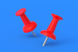 © OlekStock - Push pins on blue background. Stationery tools. Office equipment. School education. 3d render
