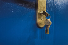 Close Up Photo Of Door Lock With Keys In It On The Blue Door