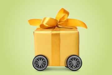 Canvas Print - Gift box on wheels against yellowish green background. Delivery service