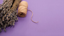 Bouquets Of Dried Lavender On A Purple Background And A Reel With A Jute Rope In The Form Of A Banner