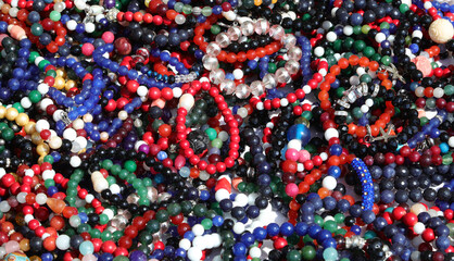 Wall Mural - background of lots of cheesy colorful beaded bracelets and bangles for sale in the flea market stall