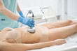 Person removing excess fat from belly with radiofrequency method