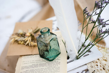 a paper envelope lies on the snow with a dry bouquet