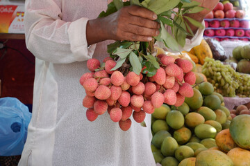 Wall Mural - men selling Lychee at local store in bangladesh 