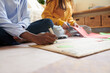 © DragonImages - Close-up image of friends creating placard for climate change awareness campaign