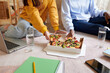 © DragonImages - Students eating supreme pizza after finishing preparing for online test