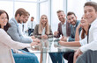 © ASDF - successful business team sitting at the table in the conference room
