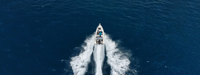 Wall Mural - Aerial drone ultra wide photo of luxury rigid inflatable speed boat cruising in high speed in Aegean deep blue sea, Greece