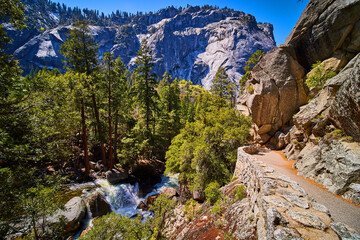 Wall Mural - Hiking trail on cliffs overlooking waterfall and stunning Yosemite valley