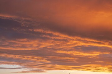 Wall Mural - Orange glowing cloud formation during sunset