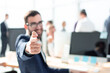 © ASDF - successful businessman sitting at his Desk and pointing at you