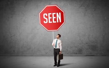 Young business person holding road sign