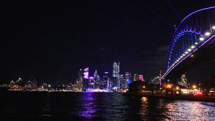 Poster - Urban cityscape skyline on shores of Sydney Harbour at Vivid Sydney show 4k.
