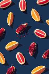 Wall Mural - Flat lay pattern with summer citrus fruit on blue background. Minimal concept with sharp shadows. Trendy social mockup or wallpaper.