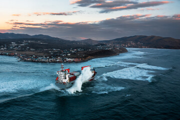 Container ship on stormy sea delivering cargo