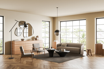 Light living room interior with couch and two chairs, drawer and window