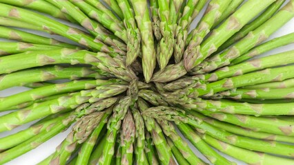 Wall Mural - Green asparagus on a light table, rotation. Fresh and tasty organic asparagus