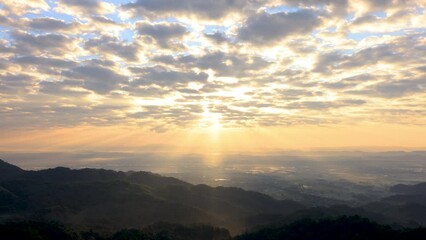 Wall Mural - morning sun shining through heavy clouds above and mountain valley. time lapse 4k video