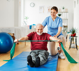 nurse doctor senior care exercise physical therapy exercising help assistence retirement home physiotherapy strech band clinic therapist elderly man