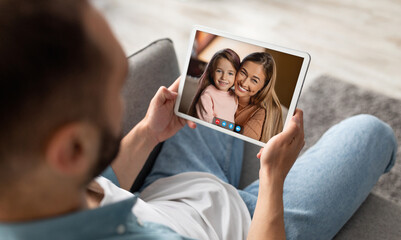 Poster - Unrecognizable young guy having video call with family on tablet