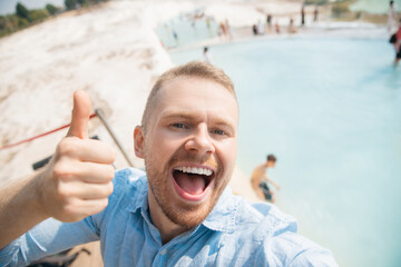 Wall Mural - Adventure tourist man make selfie background denizli travertine pools blue water in Pamukkale Turkey