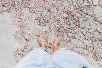 Wall Mural - Legs of tourist in travertine pools blue water in Pamukkale Turkey, top view