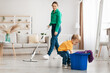 © Prostock-studio - Little boy helping young mother cleaning at home, child getting rag out of bucket while mom mopping floor